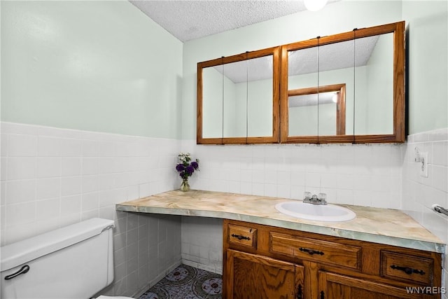 270 N French Rd, Amherst, NY 14228 - half bath with tile walls, a textured ceiling, vanity, and a wainscoted wall
