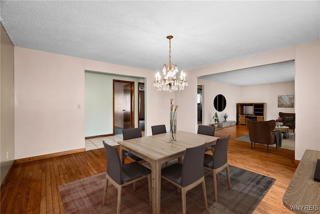 270 N French Rd, Amherst, NY 14228 - dining space with a chandelier and light wood-style flooring