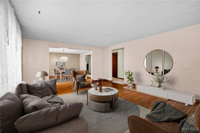 270 N French Rd, Amherst, NY 14228 - living area with wood finished floors, a chandelier, and a textured ceiling