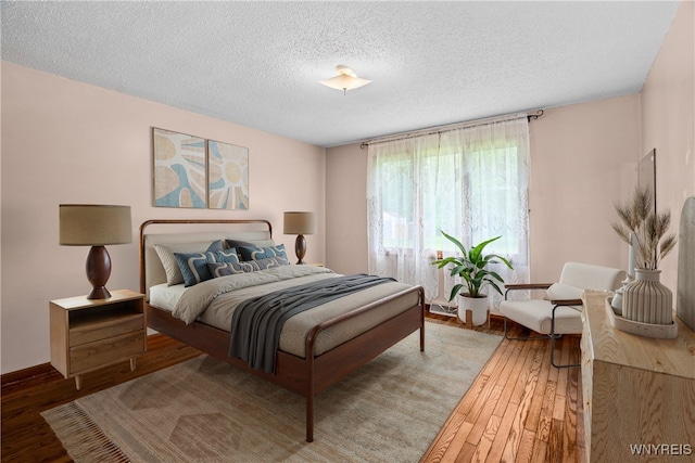 270 N French Rd, Amherst, NY 14228 - bedroom with a textured ceiling and hardwood / wood-style floors