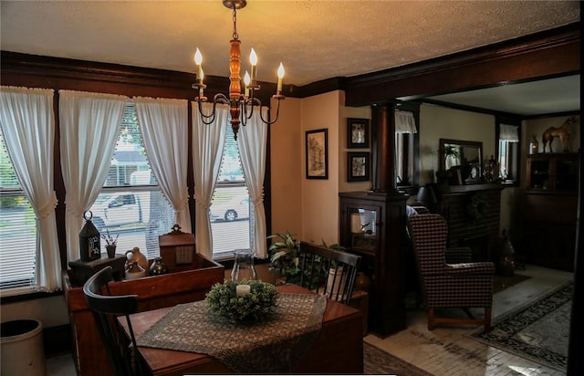 561 W Washington Ave, Elmira City, NY 14901 - dining area featuring a chandelier, crown molding, and decorative columns