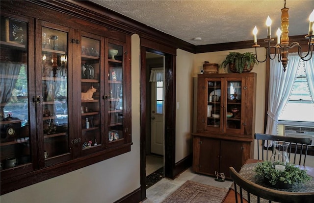 561 W Washington Ave, Elmira City, NY 14901 - dining room featuring a textured ceiling, crown molding, and a chandelier