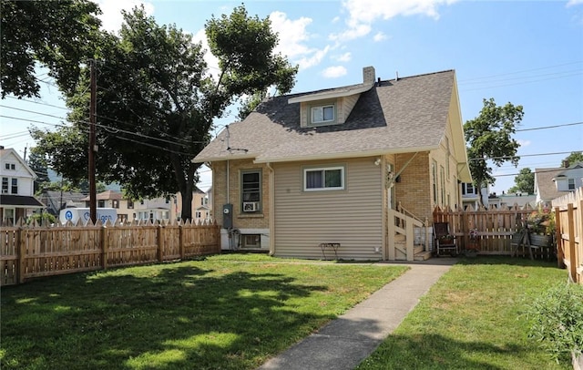 561 W Washington Ave, Elmira City, NY 14901 - rear view of house featuring a fenced backyard, a chimney, brick siding, and a shingled roof