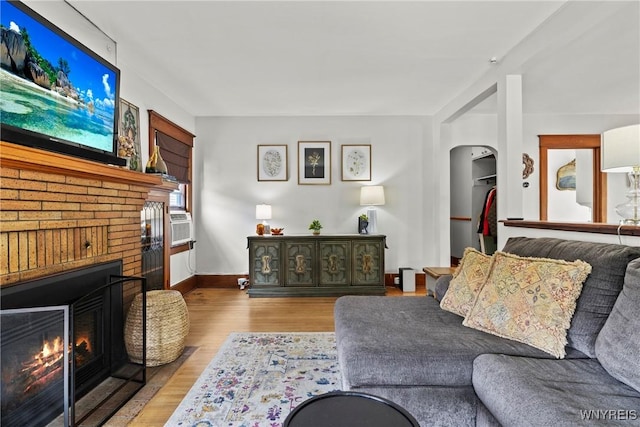 49 Mang Ave, Tonawanda, NY 14217 - living room featuring a fireplace, wood finished floors, and arched walkways