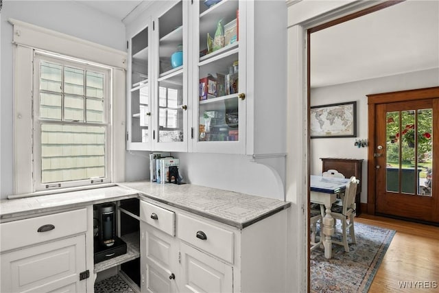 49 Mang Ave, Tonawanda, NY 14217 - kitchen with white cabinets, glass insert cabinets, and wood finished floors