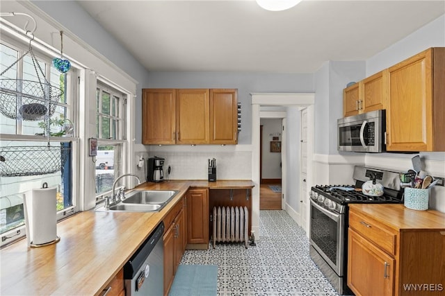 49 Mang Ave, Tonawanda, NY 14217 - kitchen featuring stainless steel appliances, radiator, butcher block counters, light flooring, and backsplash