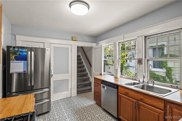 49 Mang Ave, Tonawanda, NY 14217 - kitchen with appliances with stainless steel finishes, light countertops, brown cabinetry, and light flooring