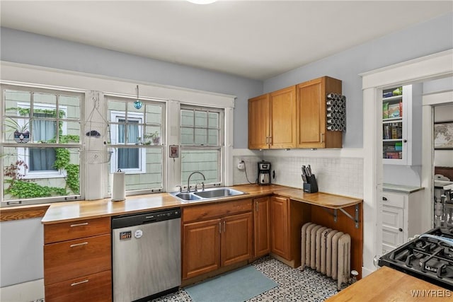49 Mang Ave, Tonawanda, NY 14217 - kitchen with dishwasher, radiator heating unit, tasteful backsplash, brown cabinetry, and range with gas stovetop