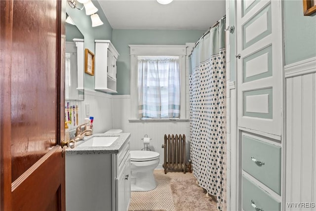 49 Mang Ave, Tonawanda, NY 14217 - bathroom featuring radiator, vanity, a wainscoted wall, a shower with shower curtain, and tile patterned floors