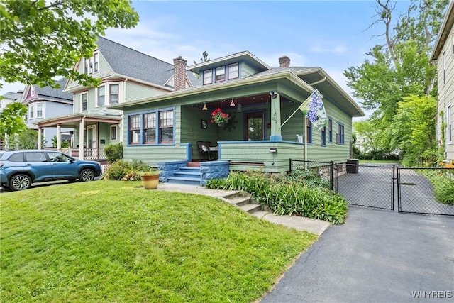 49 Mang Ave, Tonawanda, NY 14217 - view of front of house with covered porch, a gate, and a chimney