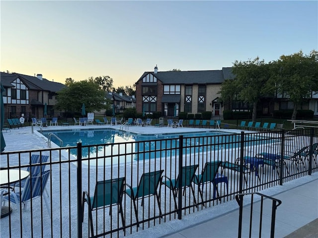 157 New Wickham Dr, Penfield, NY 14526 - pool at dusk featuring a community pool, a patio area, and a residential view