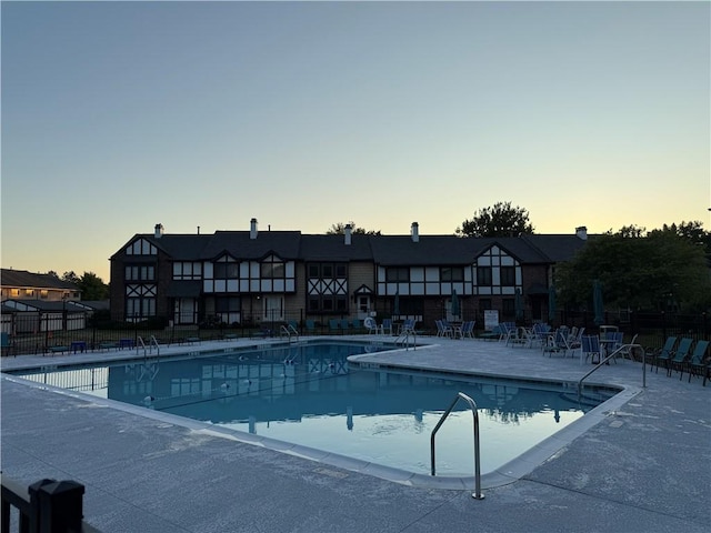 157 New Wickham Dr, Penfield, NY 14526 - pool at dusk with a community pool and a patio