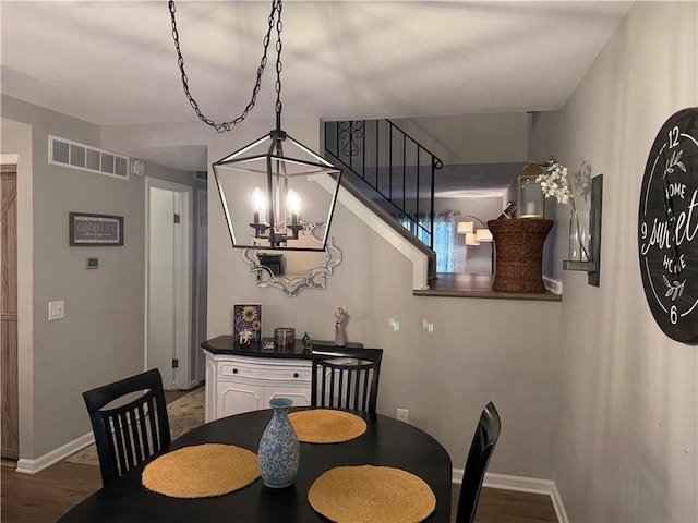 157 New Wickham Dr, Penfield, NY 14526 - dining space featuring a chandelier, wood finished floors, and stairs