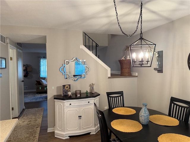 157 New Wickham Dr, Penfield, NY 14526 - dining space featuring a chandelier, dark wood-style flooring, and stairway