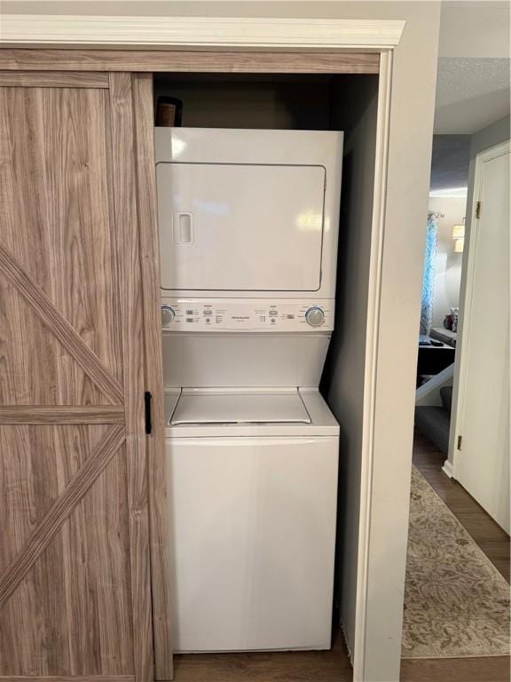 157 New Wickham Dr, Penfield, NY 14526 - laundry room featuring estacked washer and dryer and wood finished floors