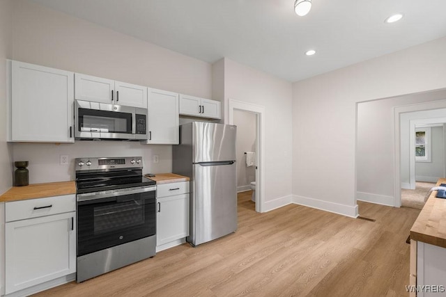 145 14th St, Buffalo, NY 14213 - kitchen with stainless steel appliances, wooden counters, light wood-style flooring, white cabinets, and recessed lighting