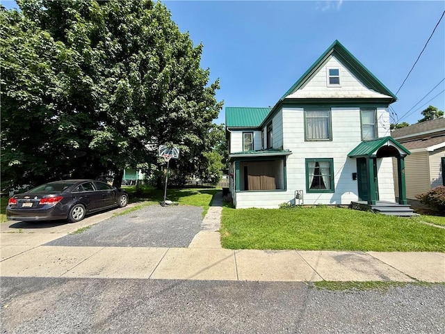 8 Church St, Waterloo, NY 13165 - view of front facade with a front yard, a metal roof, and driveway
