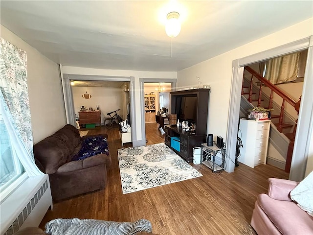 8 Church St, Waterloo, NY 13165 - living room with radiator heating unit, wood finished floors, and stairway