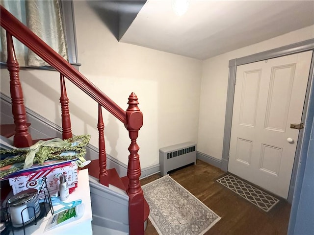 8 Church St, Waterloo, NY 13165 - entrance foyer featuring radiator heating unit, stairway, and wood finished floors