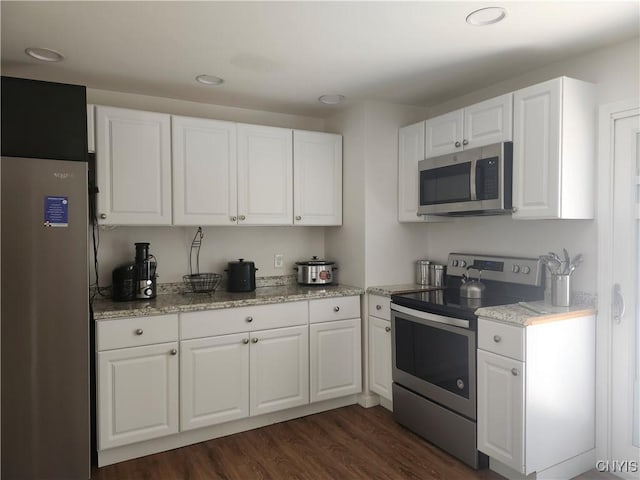 219 Camillus Dr, Camillus, NY 13031 - kitchen featuring appliances with stainless steel finishes, white cabinetry, dark wood-style flooring, recessed lighting, and light stone counters