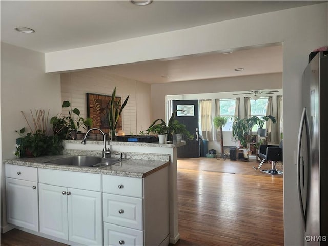 219 Camillus Dr, Camillus, NY 13031 - kitchen featuring freestanding refrigerator, a peninsula, white cabinets, and dark wood-style floors