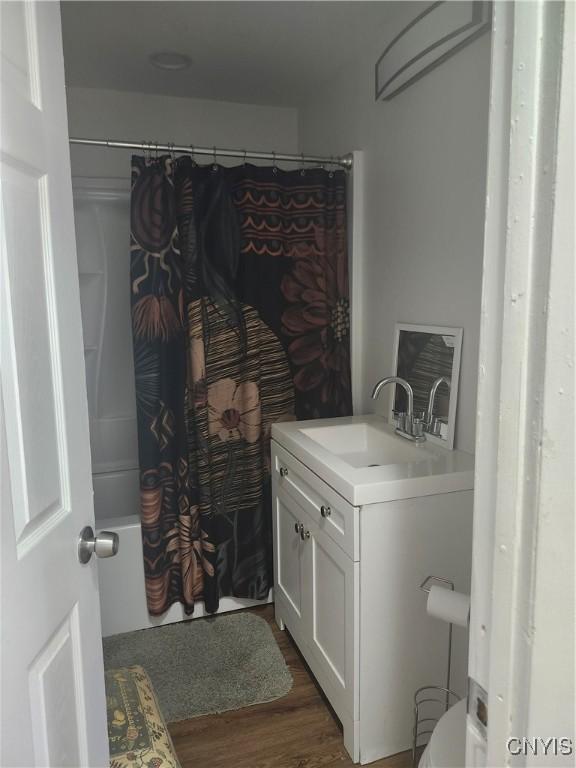 219 Camillus Dr, Camillus, NY 13031 - laundry room featuring a sink and dark wood-style flooring