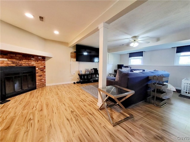 128 Dorando Way, Salina, NY 13090 - living area with wood finished floors, a ceiling fan, and a brick fireplace