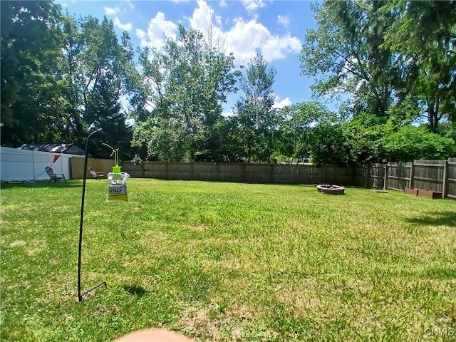 128 Dorando Way, Salina, NY 13090 - fenced backyard featuring an outdoor fire pit
