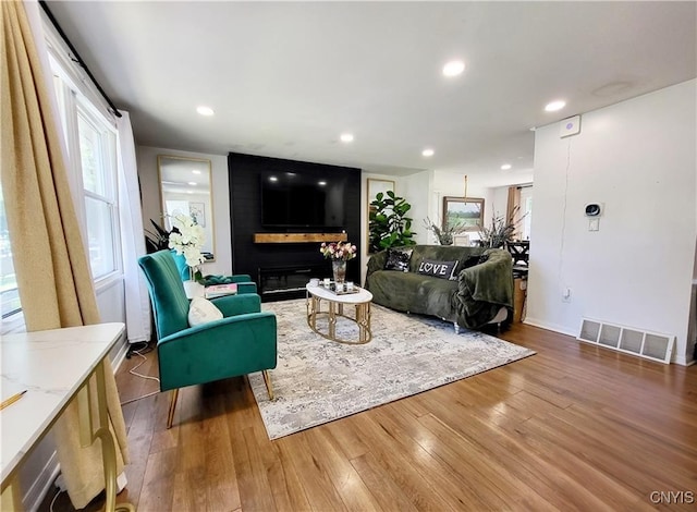 128 Dorando Way, Salina, NY 13090 - living area with wood finished floors, recessed lighting, and a large fireplace