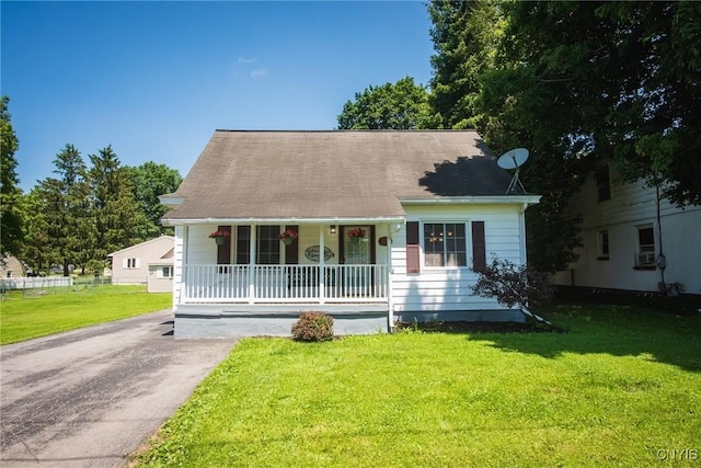 123 Branch St, Deerfield, NY 13502 - cape cod home featuring a porch, a front yard, and driveway
