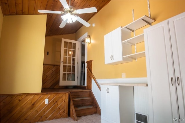 123 Branch St, Deerfield, NY 13502 - stairway with wood ceiling, a wainscoted wall, a ceiling fan, and lofted ceiling
