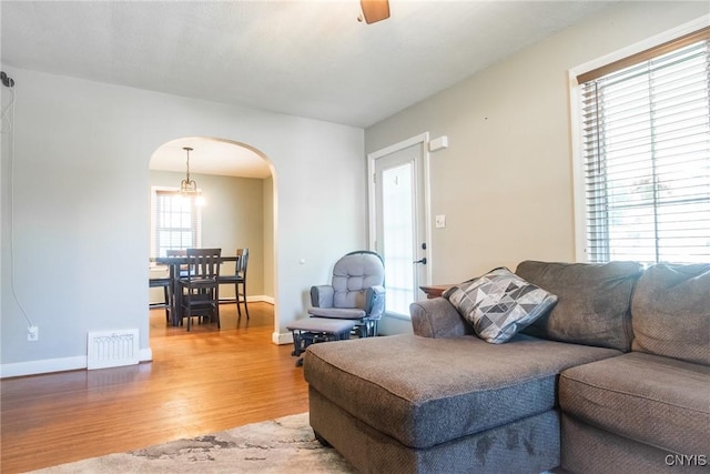 123 Branch St, Deerfield, NY 13502 - living area with arched walkways, wood finished floors, and a ceiling fan