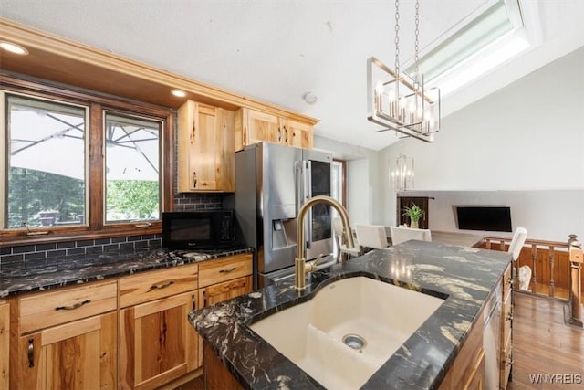 131 Shady Grove Dr, Amherst, NY 14051 - kitchen featuring stainless steel fridge with ice dispenser, black microwave, a chandelier, vaulted ceiling, and decorative backsplash
