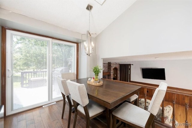 131 Shady Grove Dr, Amherst, NY 14051 - dining area featuring lofted ceiling, wood finished floors, and a chandelier