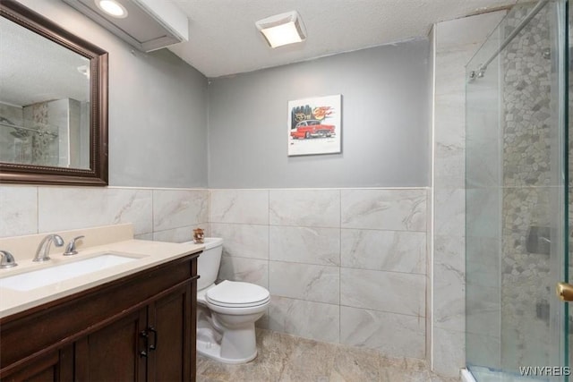 131 Shady Grove Dr, Amherst, NY 14051 - full bathroom featuring vanity, tile walls, a stall shower, and wainscoting
