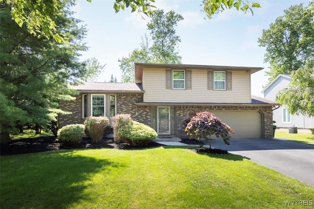 131 Shady Grove Dr, Amherst, NY 14051 - split level home featuring asphalt driveway, an attached garage, a front yard, and brick siding