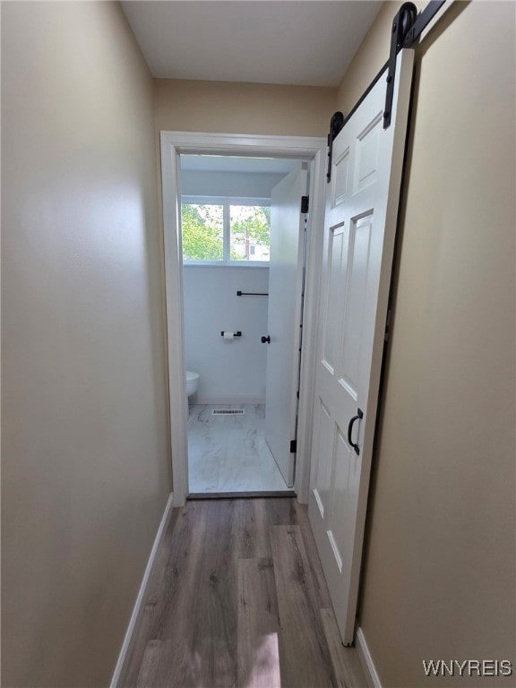 24 Wenonah, Tonawanda, NY 14150 - corridor featuring a barn door and wood finished floors