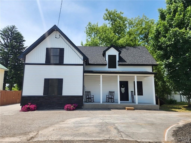 8457 S Main St, Le Ray, NY 13637 - view of front of house with covered porch, roof with shingles, and stone siding