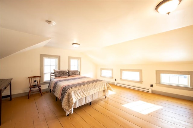 345 Dorr Edson Rd, Milford, NY 13820 - bedroom featuring a baseboard radiator, vaulted ceiling, and light wood-style floors