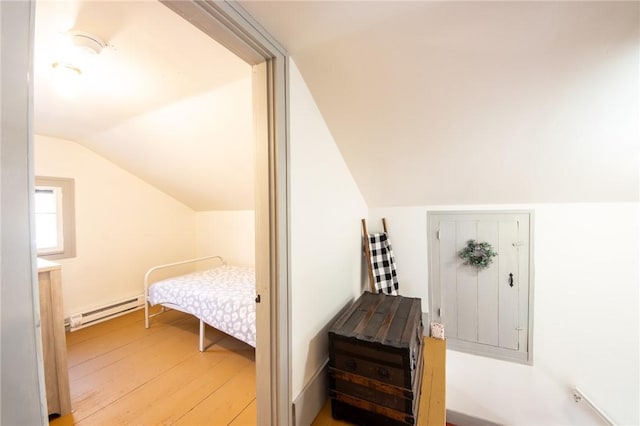 345 Dorr Edson Rd, Milford, NY 13820 - bedroom featuring baseboard heating, lofted ceiling, and wood-type flooring