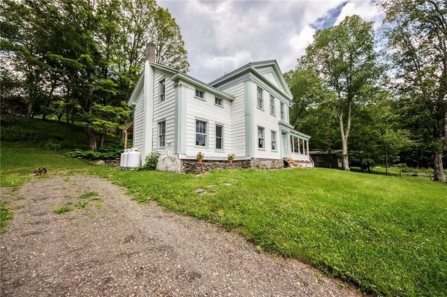 345 Dorr Edson Rd, Milford, NY 13820 - view of home's exterior with a chimney, a yard, and view of wooded area