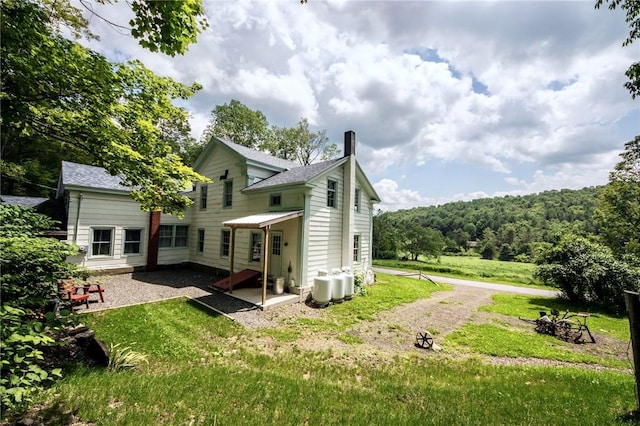345 Dorr Edson Rd, Milford, NY 13820 - rear view of house with a lawn, an outdoor fire pit, a chimney, and a shingled roof