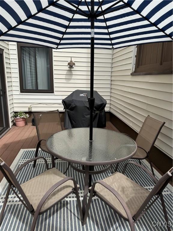 601 Woburn Dr, Camillus, NY 13031 - deck with outdoor dining area and a grill