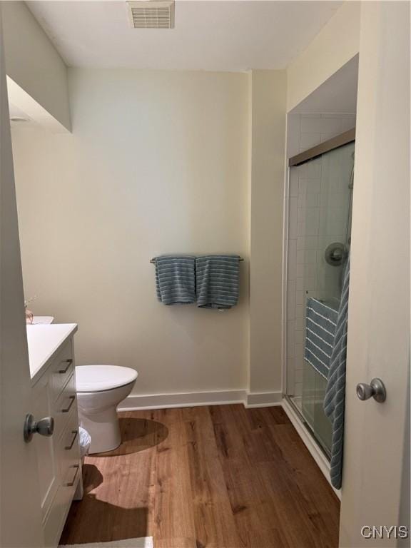 601 Woburn Dr, Camillus, NY 13031 - bathroom featuring vanity, a shower stall, and wood finished floors