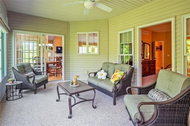 1100 Yorkshire Way, Victor, NY 14564 - sunroom / solarium featuring a ceiling fan, healthy amount of natural light, wooden walls, and carpet flooring