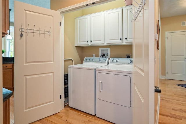 1100 Yorkshire Way, Victor, NY 14564 - washroom featuring cabinet space, washing machine and dryer, and light wood-style flooring