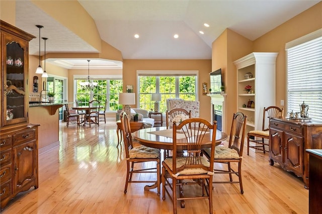 1100 Yorkshire Way, Victor, NY 14564 - dining area with light wood-style floors, vaulted ceiling, a fireplace, and recessed lighting