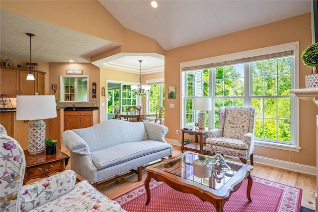 1100 Yorkshire Way, Victor, NY 14564 - living area featuring vaulted ceiling, a chandelier, light wood-style floors, and recessed lighting