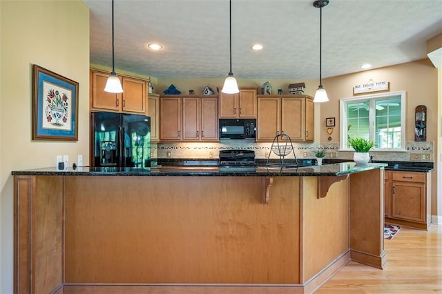 1100 Yorkshire Way, Victor, NY 14564 - kitchen with black appliances, light wood finished floors, tasteful backsplash, dark stone counters, and brown cabinetry