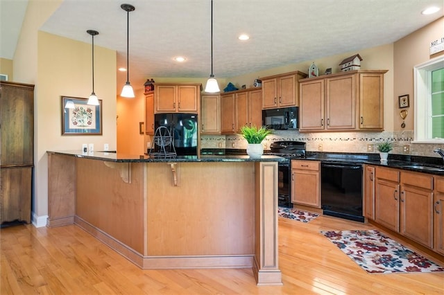 1100 Yorkshire Way, Victor, NY 14564 - kitchen with black appliances, light wood-style floors, backsplash, a kitchen bar, and decorative light fixtures